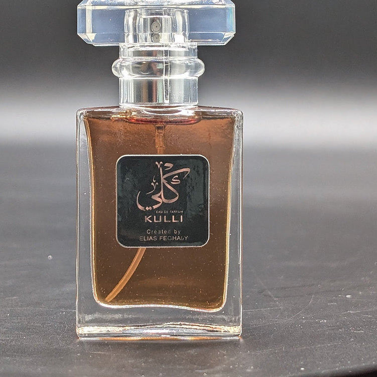 Perfume bottle with 'GULLI' label on a dark surface
